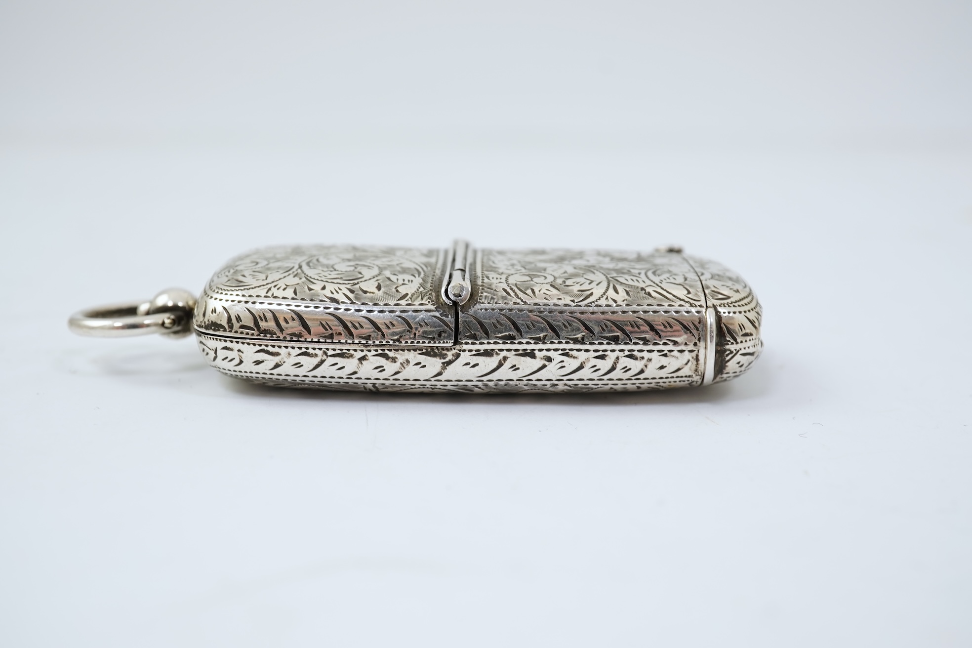 A late Victorian engraved silver oval combination sovereign and vesta case, by W H Tandy & Sons